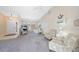 Inviting living room boasting vaulted ceilings, neutral tones, carpeted flooring, and an abundance of natural light at 18395 Edgewater Dr, Port Charlotte, FL 33948