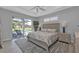 Relaxing bedroom with tray ceilings, ceiling fan, and glass doors to the pool at 2137 Onondaga Ln, Punta Gorda, FL 33983