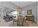 Dining area with sliding glass doors to the lanai and outdoor pool at 2137 Onondaga Ln, Punta Gorda, FL 33983