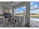 A covered outdoor kitchen featuring a stainless steel grill, sink, and granite countertop at 2137 Onondaga Ln, Punta Gorda, FL 33983