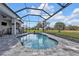 Sparkling swimming pool with a screened enclosure offering views of the landscaped lawn at 2137 Onondaga Ln, Punta Gorda, FL 33983