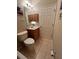 Compact bathroom featuring tiled floors, a vanity, and a toilet at 24157 Green Heron Dr # 27, Punta Gorda, FL 33980