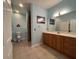 Bathroom vanity features wood cabinets, light fixture, and framed mirror at 24157 Green Heron Dr # 27, Punta Gorda, FL 33980