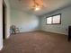 Large bedroom offers ample space with neutral carpeting and a ceiling fan at 24157 Green Heron Dr # 27, Punta Gorda, FL 33980