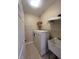 Efficient laundry room with washer, dryer, sink, and ample storage shelving at 24157 Green Heron Dr # 27, Punta Gorda, FL 33980