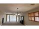 Spacious living room features high ceilings, large windows, and a chandelier at 24157 Green Heron Dr # 27, Punta Gorda, FL 33980