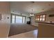 Open-concept living room featuring a chandelier, hardwood floors, and ample natural light at 24157 Green Heron Dr # 27, Punta Gorda, FL 33980