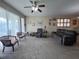 Inviting living room with large windows, comfortable seating, and neutral carpet at 24157 Green Heron Dr # 27, Punta Gorda, FL 33980