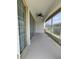Enclosed patio with tile floor, large windows, and a ceiling fan, perfect for relaxation at 24157 Green Heron Dr # 27, Punta Gorda, FL 33980