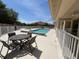 Outdoor pool area featuring patio furniture and well-maintained landscaping, ideal for entertaining at 24157 Green Heron Dr # 27, Punta Gorda, FL 33980