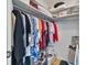 Walk-in closet showing hanging clothing on a chrome bar with storage shelves overhead at 2763 Woodgate Ln # 206, Sarasota, FL 34231