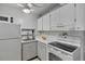 Efficient kitchen with white appliances and cabinets, and ample counter space at 2763 Woodgate Ln # 206, Sarasota, FL 34231