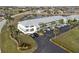 An aerial view of a well-maintained condominium complex with ample parking, lush landscaping, and serene surroundings at 3600 Bal Harbor Blvd # 1A, Punta Gorda, FL 33950