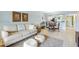 Cozy living room featuring a comfortable sofa, stylish furnishings, and an open layout connected to the dining area at 3600 Bal Harbor Blvd # 1A, Punta Gorda, FL 33950