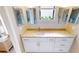 Bathroom featuring a single sink vanity with granite countertops, a window, and multiple mirrors at 3830 Bal Harbor Blvd # 5, Punta Gorda, FL 33950
