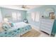 Bedroom featuring a queen bed, a ceiling fan, blue accent wall, dresser, and a coastal theme at 3830 Bal Harbor Blvd # 5, Punta Gorda, FL 33950