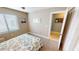 This bedroom has carpeted floors, beach themed wall art, and a window with blinds at 3830 Bal Harbor Blvd # 5, Punta Gorda, FL 33950