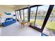 Relax in this sunroom with comfortable seating and a beautiful view of the canal and neighboring homes at 3830 Bal Harbor Blvd # 5, Punta Gorda, FL 33950