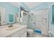 Clean bathroom with white vanity, tiled shower, and modern fixtures in a soothing blue color scheme at 483 Winwood Ct, Port Charlotte, FL 33954