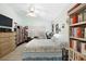 Bright bedroom with tile floors, ceiling fan, a queen bed and ample storage options at 483 Winwood Ct, Port Charlotte, FL 33954