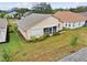 Back exterior view of home with small, enclosed patio and manicured lawn and garden at 483 Winwood Ct, Port Charlotte, FL 33954