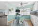 Cozy kitchen nook features a round table, four chairs, ample natural light, and tile flooring at 483 Winwood Ct, Port Charlotte, FL 33954