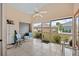 Relaxing screened lanai with tile flooring, neutral tones, and views of the backyard and surrounding neighborhood at 483 Winwood Ct, Port Charlotte, FL 33954