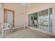Covered lanai featuring tile flooring, seating, and sliding glass doors leading to the home's interior at 483 Winwood Ct, Port Charlotte, FL 33954