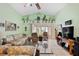 Inviting living room with vaulted ceilings, tile flooring, comfortable seating, and access to the screened lanai at 483 Winwood Ct, Port Charlotte, FL 33954