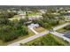 An overhead view captures the home's setting in a lush, green neighborhood with surrounding homes at 5452 Montego Ln, Port Charlotte, FL 33981