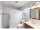 Clean bathroom with a shower, vanity, toilet, and a framed mirror above the sink at 5452 Montego Ln, Port Charlotte, FL 33981