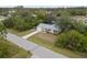 Charming single-story home with a well-manicured lawn and mature trees at 5452 Montego Ln, Port Charlotte, FL 33981