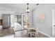 Cozy dining area featuring a table, chairs, and natural light from the sliding glass doors to the pool at 5452 Montego Ln, Port Charlotte, FL 33981