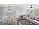 Open living space features modern decor, connecting the kitchen, dining, and living area with natural light at 5452 Montego Ln, Port Charlotte, FL 33981