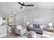 Open-concept living room with stylish furniture, neutral tones, and access to an outdoor dining area at 5452 Montego Ln, Port Charlotte, FL 33981