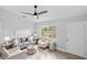 Bright living room featuring modern furniture and decor, a ceiling fan, and natural light at 5452 Montego Ln, Port Charlotte, FL 33981