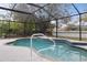 Inviting screened pool featuring a decorative tile border and convenient access ladder at 5452 Montego Ln, Port Charlotte, FL 33981