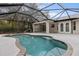 A refreshing screened pool with an attached covered patio offers an enjoyable outdoor living space at 5452 Montego Ln, Port Charlotte, FL 33981