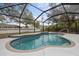Inviting in-ground pool inside a screened enclosure offers a great place to relax at 5452 Montego Ln, Port Charlotte, FL 33981