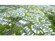 Aerial view of the manufactured home community, showcasing lush lawns and a swimming pool at 6642 Acacia Ct, North Port, FL 34287