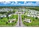Aerial view of a manufactured home community with lush lawns, mature trees and beautiful landscaping at 6642 Acacia Ct, North Port, FL 34287