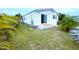 A well-kept backyard with a white house and sliding glass door at 6642 Acacia Ct, North Port, FL 34287