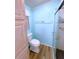 Clean bathroom with a toilet, linen cabinet, and access to the tiled shower at 6642 Acacia Ct, North Port, FL 34287