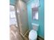 Bathroom with a toilet, built in linen cabinet, wood-look tile, and access to a sink vanity at 6642 Acacia Ct, North Port, FL 34287