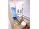A bright bathroom with a white sink, toilet, and mirrored cabinet at 6642 Acacia Ct, North Port, FL 34287