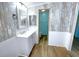 Bathroom featuring a white cabinet vanity, wood-look tile flooring, and bright decor at 6642 Acacia Ct, North Port, FL 34287