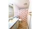 A well-lit bathroom with a floral shower curtain and modern fixtures at 6642 Acacia Ct, North Port, FL 34287