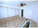 A bright bedroom featuring built-in storage, a ceiling fan, and light-colored flooring at 6642 Acacia Ct, North Port, FL 34287