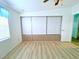 A clean and bright bedroom with built-in storage and light-colored flooring at 6642 Acacia Ct, North Port, FL 34287