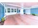 Spacious carport with painted floor and decorative privacy fence and entry to the home at 6642 Acacia Ct, North Port, FL 34287